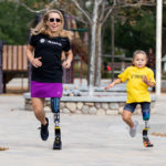 Sarah Reinertsen runs mentors Morgan Pixley, age 5